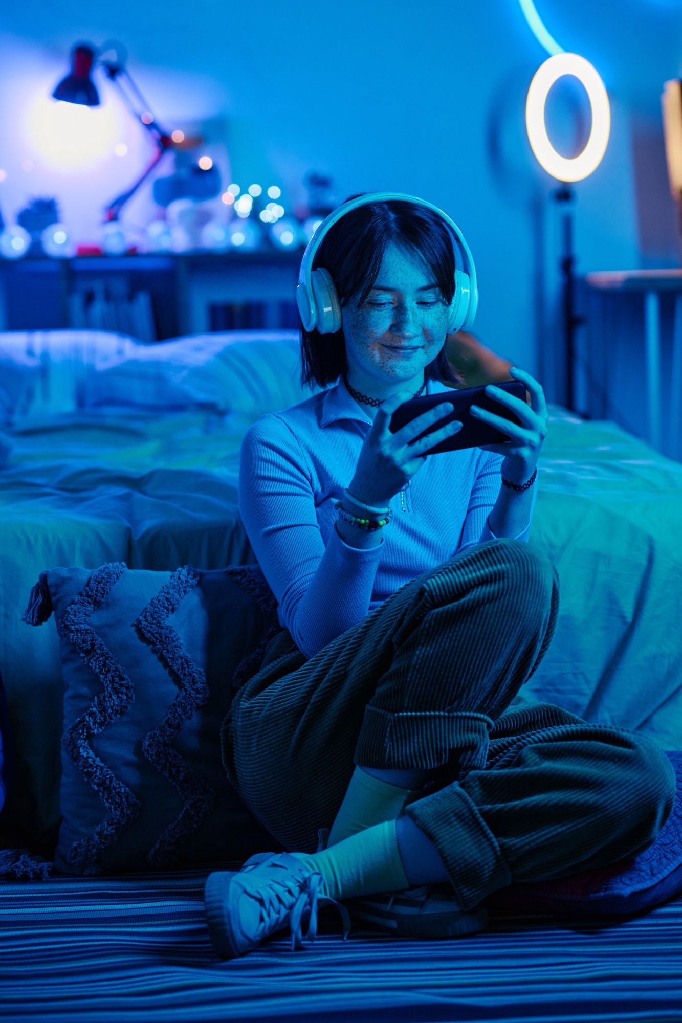 Girl playing video game on smartphone